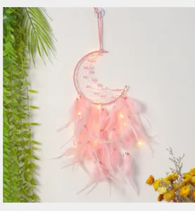 Pink moon dreamcatcher detail with LED lights and feather decor for bedroom wall hanging.
