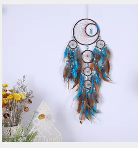 Turquoise tree of life dream catcher wall hanging detail, featuring feathers and beads.