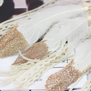 Handcrafted dream catcher feather hanging ornament with gold glitter and lace for home decor.