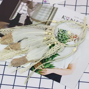 Handmade white lace dream catcher with gold glitter feathers and wooden beads hanging decor