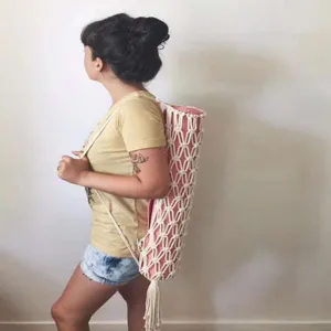 Handmade cotton macrame yoga mat strap and carrier net bag for convenient outdoor fitness practice.