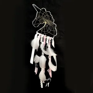 Unicorn dream catcher detail showing black and white feathers and intricate gold web.