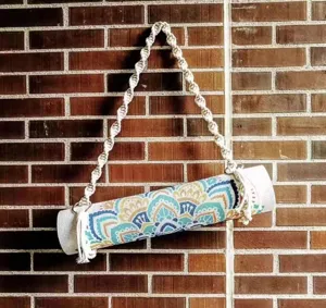 Handmade macrame cotton yoga mat strap detail, boho style yoga storage hanger rope.