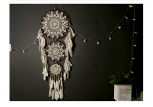 Bohemian three-ring dream catcher wall hanging detail, white crochet lace with feathers.