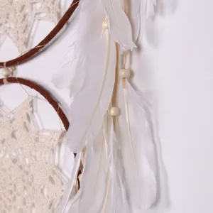 Boho handmade dream catcher wall hanging with white feathers and wood beads decor.