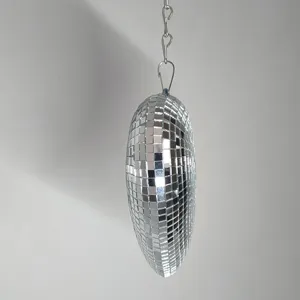 Close-up detail view of hanging silver heart disco mirror ball for party event decoration.