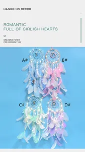 Double circle merry go round dream catcher with feathers and fairy lights for bedroom decor.
