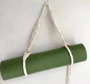 Handmade woven cotton yoga strap detail, minimalist mat carrier for easy home storage and fitness.