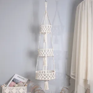 Three-tier macrame hanging basket made of cotton rope, perfect for fruit and plant display.