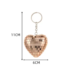 Detail view of the shimmering heart-shaped disco ball keychain with reflective mirror surface.