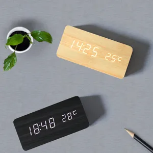 Detailed view of wooden LED digital alarm clock showing clear time and temperature.