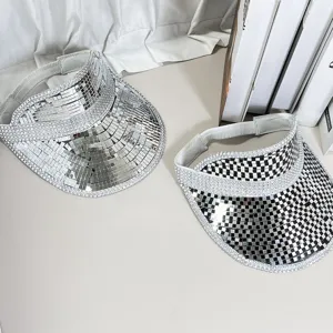 Close up detail of silver mirror disco sun visors, shiny reflective empty top hat for party.