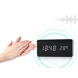 Wooden smart voice-controlled LED digital alarm clock detail showing temperature and time display.