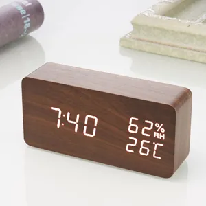 Close-up view of the wooden LED digital alarm clock displaying clear time and temperature.