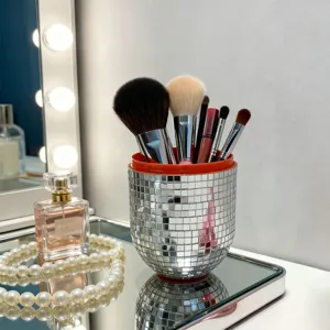 Disco ball makeup brush holder detail shot, shiny mirror mosaic pen cup vanity organizer.