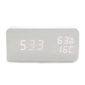 Close-up detail of the wooden digital LED alarm clock showing clear time and temperature data.