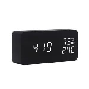 Detailed close-up view of the black wooden LED digital clock displaying time and environmental data.