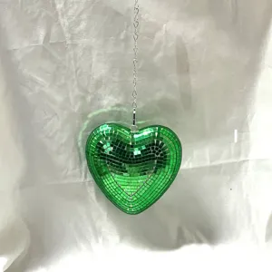 Green heart disco ball hanging decoration with silver chain, perfect for party atmosphere and room decor.