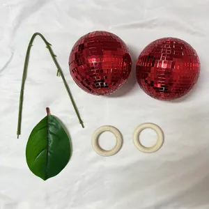 Red mirror disco balls set with DIY leaf and wooden ring accessories for party home decor.