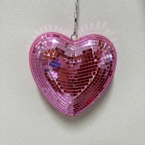 Pink heart disco ball detail view hanging mirror decor for party atmosphere reflection.