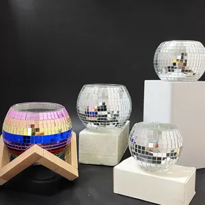 Detail shot of colorful and silver disco ball mosaic candle holders on stands for home decor.