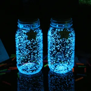 DIY luminous sand glowing particles in glass jars for night decoration and wishing bottle crafting.