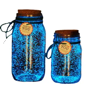 DIY luminous glow in the dark sand glass jar set with blue glowing particles and cork lid.