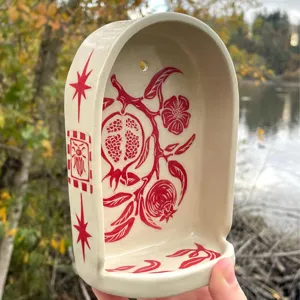 Handmade resin wall shrine niche featuring vintage pomegranate and star relief carvings.