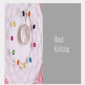 Handmade knitted dream catcher detail view showing colorful beads and shell pendant decor.