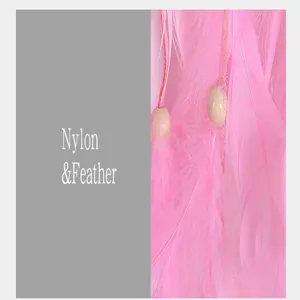 Pink dream catcher feather wall hanging detail view showing soft nylon and wooden beads material.