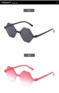 Detailed view of children's rimless polygonal sunglasses with trendy gradient lenses.