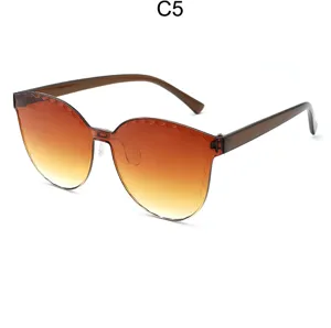 Detail shot of gradient brown frameless sunglasses with trendy scalloped edge design.