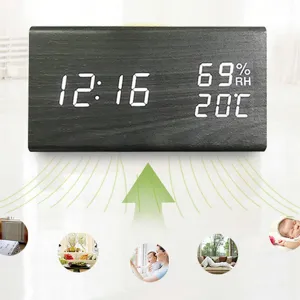 Wooden LED digital alarm clock with temperature and humidity display for home office.
