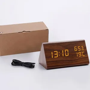 Wooden triangular LED digital alarm clock with temperature and humidity display, box and cable.
