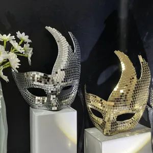 Detailed close-up of shiny disco mosaic masks in silver and gold, perfect for party decor.