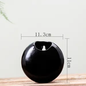 Detail shot of black ceramic wall hanging planter vase, spherical shape, minimalist 11cm.