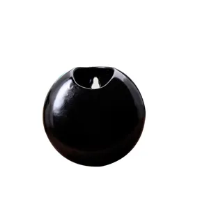 Modern black ceramic wall hanging flower pot, minimalist round planter for succulent plants.