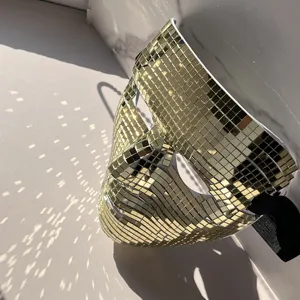 Gold disco ball mirror mask detail, sparkling mosaic face mask for party and Halloween decoration.