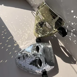 Close-up of gold and silver disco mirror masks featuring shiny mosaic surface for party decor.