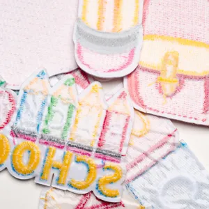 Embroidered school supply patches featuring cute pencil and backpack designs for clothing decoration.