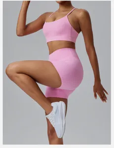 Pink sports bra and high-waisted fitness yoga shorts set for women running gym activewear.
