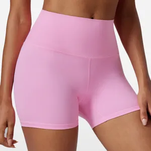 Detailed view of high-waisted pink yoga shorts featuring stretchy fabric for fitness workouts.