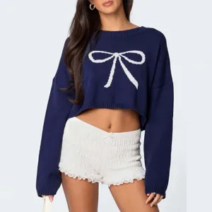 Detailansicht des dunkelblauen Strick-Crop-Pullovers mit weißem Schleifen-Muster.