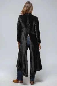 Black velvet long trench coat back slit view, elegant retro outerwear detail photography.