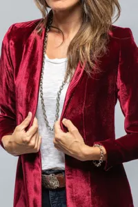 Detailed view of women's retro velvet long coat with elegant fabric and fine tailoring.