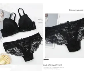 Detailed view of the black lace bra and panties set, featuring delicate floral lace and bow.