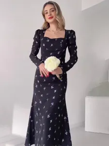 Detailed view of the elegant black floral long sleeve dress with square neckline.