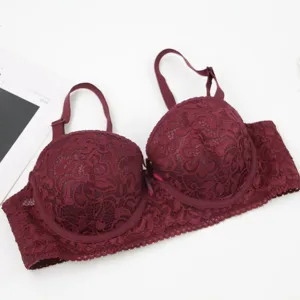 Wine red lace underwired bra close-up showing detailed floral pattern and detailed strap.