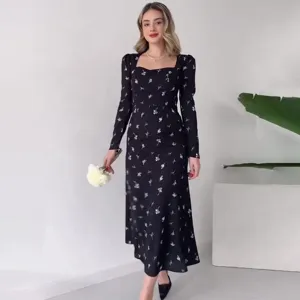 Detailed showcase view of elegant black long sleeve floral midi dress indoor scene.