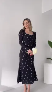 Detail view of the elegant floral print long sleeve midi dress with square neck and fishtail hem.